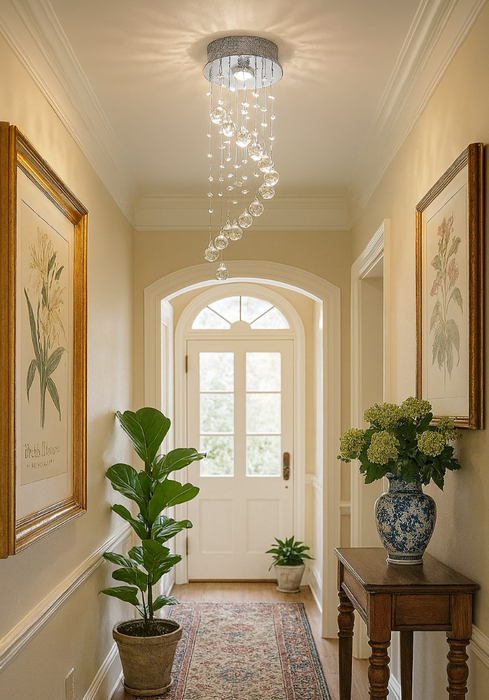 Modern crystal spiral chandelier with chrome finish and K9 glass droplets hanging in a hallway setting.