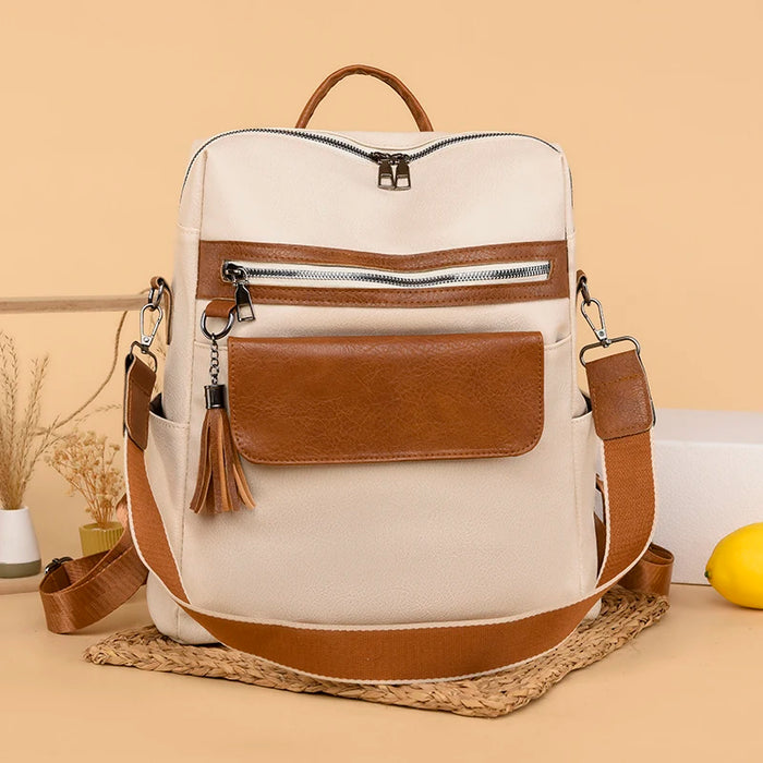 PU softback backpack for women with tassel decoration, embossed thread design, multiple interior compartments, and soft shoulder straps
