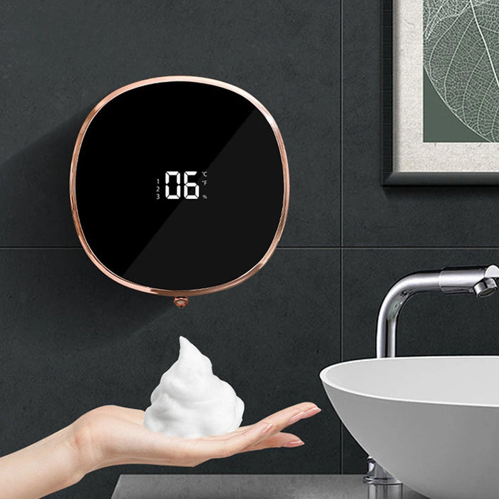 Wall-mounted automatic foaming soap dispenser with infrared sensor and modern compact design, mounted in a minimalist bathroom or kitchen setting