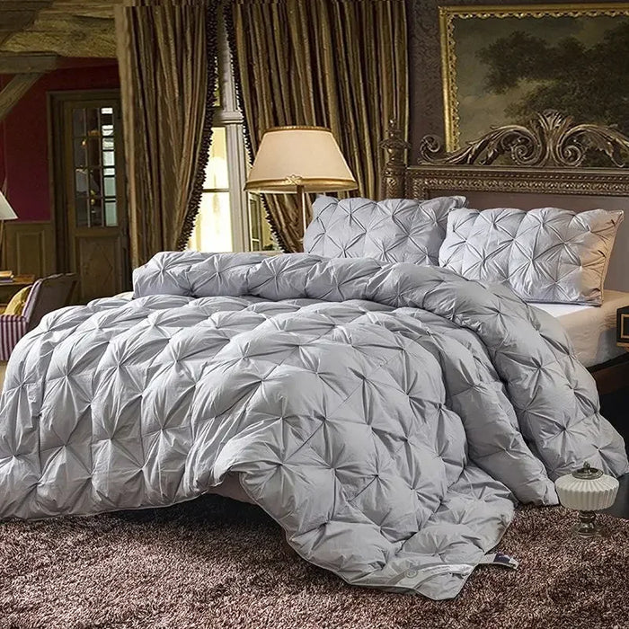 Goose down quilt with 100% cotton cover, quilted stitching, and corner straps for all-season comfort.