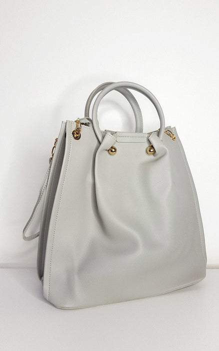 Beige faux leather handbag and shoulder bag set with gold hardware and detachable strap.