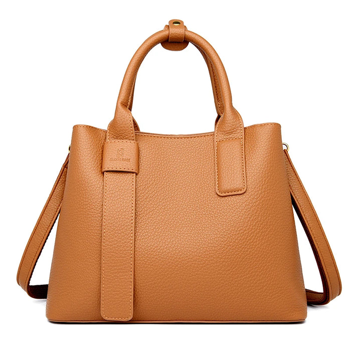 Luxury designer tote handbag in PU leather with structured design, zipper & hasp closure, and multiple interior pockets.