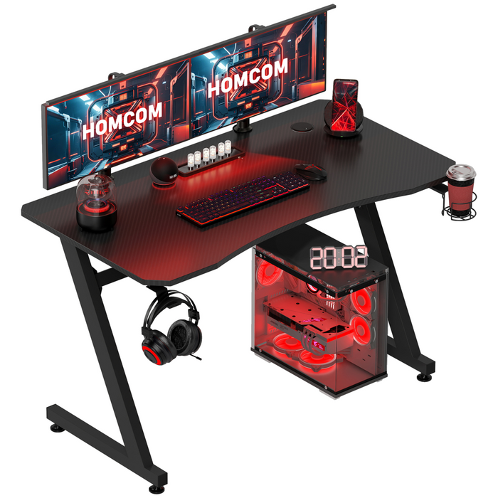 Black gaming desk with steel Z-frame, headphone hook, cup holder, and rear cable grommets