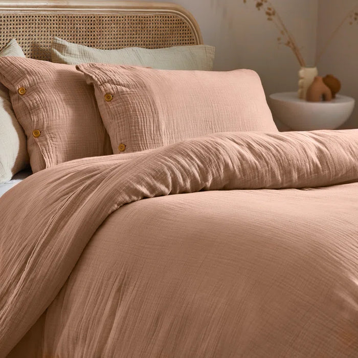 duvet cover set in pastel tones with wooden button closure, showcasing modern crinkle texture and breathable fabric.