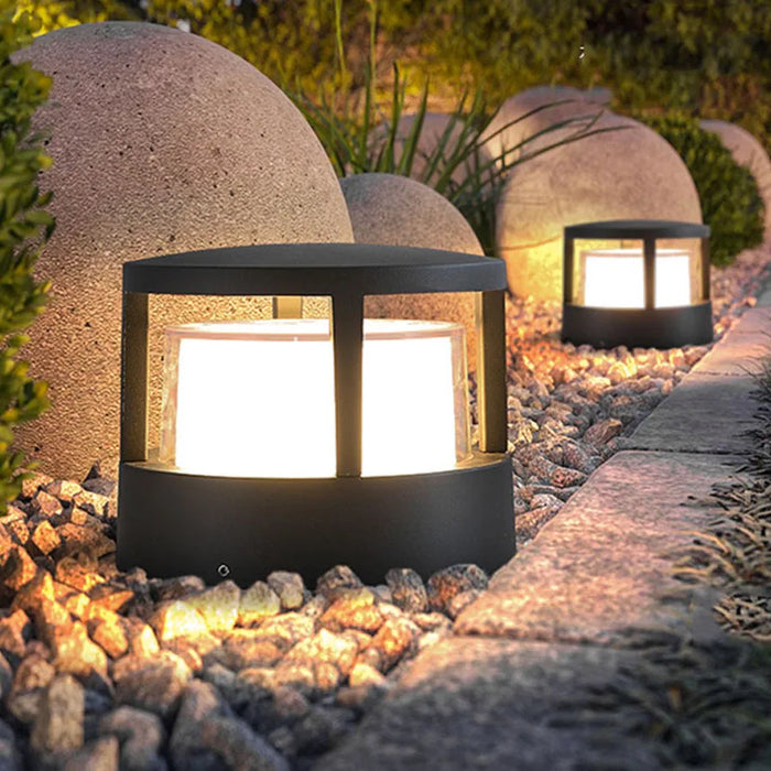 Waterproof outdoor aluminum pillar light mounted on a garden fence