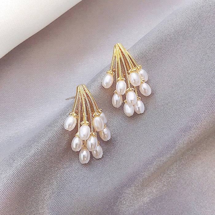 Firework pearl stud earrings with radiant design and pearl detailing, lightweight and elegant