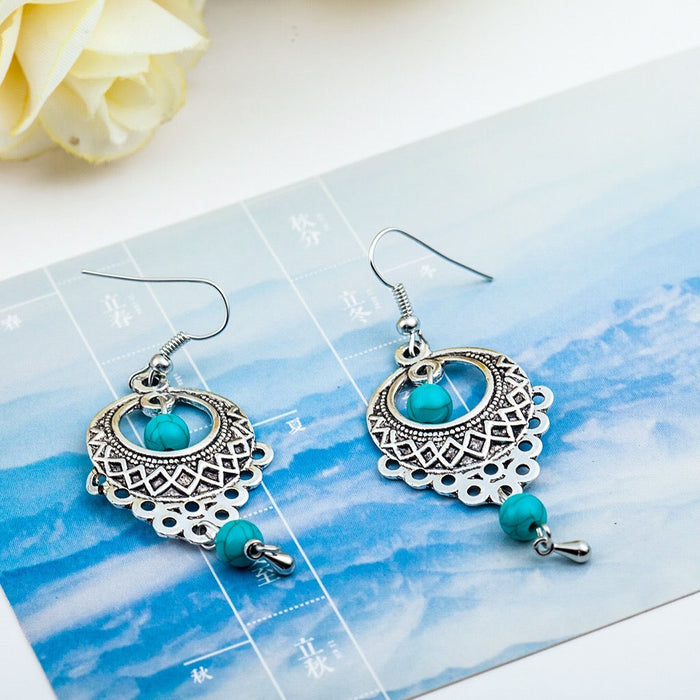 Vintage slinky drop earrings with turquoise stones and antique gold-tone finish