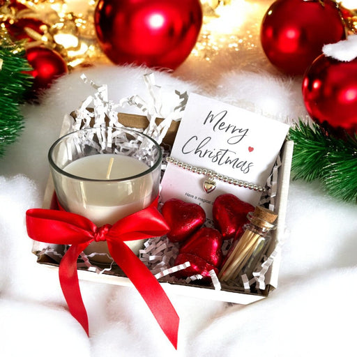 Mini Christmas gift hamper with silver heart bracelet, scented candle and caramel chocolates.