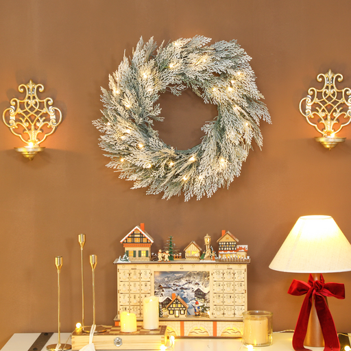 Snow-dusted LED Christmas wreath with warm white lights for indoor décor