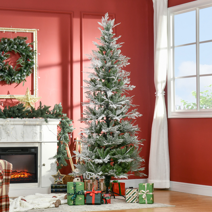 Snow-frosted artificial Christmas tree with PVC branches and metal stand
