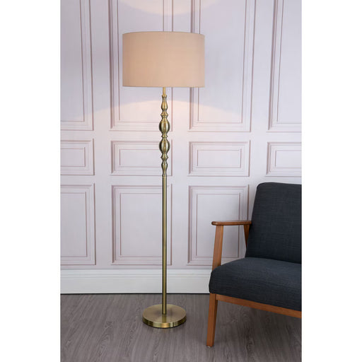 Antique brass floor lamp with beige faux silk drum shade for modern and classic interiors

