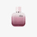 Bottle of L.12.12 Rose Eau Intense perfume with floral elements like rose, iris, cotton flower, and cedarwood in the background