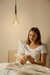 Modern aluminum pendant light hanging over a stylish dining space