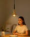 Modern aluminum pendant light hanging over a stylish dining space