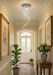 Modern crystal spiral chandelier with chrome finish and K9 glass droplets hanging in a hallway setting.