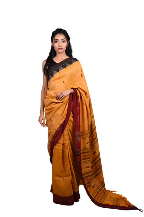 Handwoven Kotpad Saree with tribal motifs, natural earthy tones, and matching blouse piece
