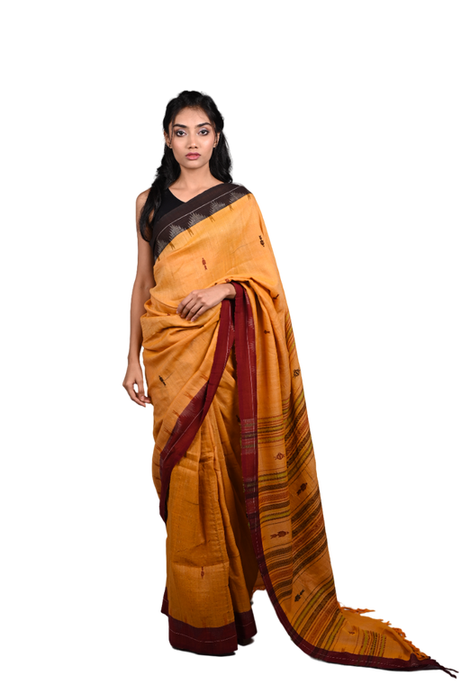 Handwoven Kotpad Saree with tribal motifs, natural earthy tones, and matching blouse piece