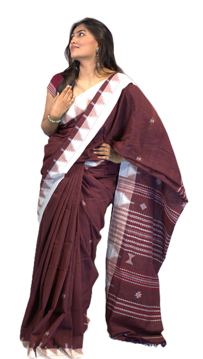 Elegant Kotpad saree handwoven in Odisha with natural Aul tree dyes, tribal motifs, and matching blouse piece