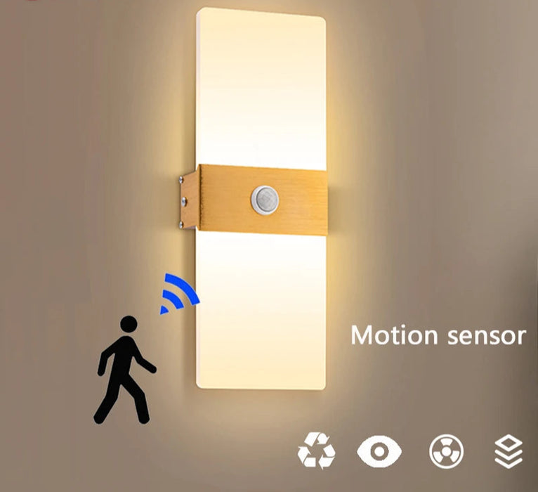 Modern LED wall light with PIR motion sensor, up & down design, black aluminum body, and acrylic shade for bedroom and corridor lighting