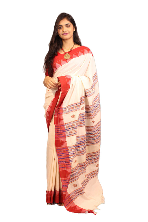 Elegant Kotpad saree handwoven in Odisha with natural Aul tree dyes, tribal motifs, and matching blouse piece