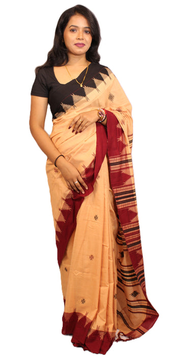 Elegant Kotpad saree handwoven in Odisha with natural Aul tree dyes, tribal motifs, and matching blouse piece