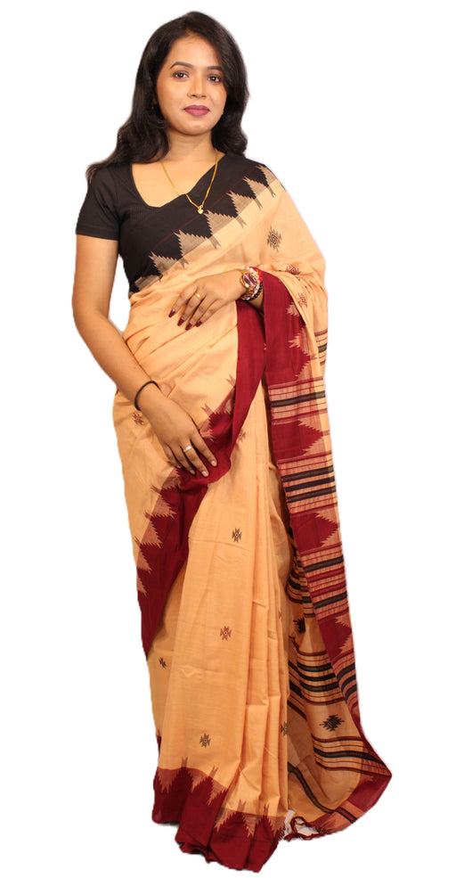 Elegant Kotpad saree handwoven in Odisha with natural Aul tree dyes, tribal motifs, and matching blouse piece