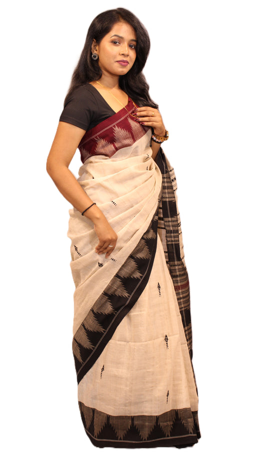 Elegant Kotpad saree handwoven in Odisha with natural Aul tree dyes, tribal motifs, and matching blouse piece