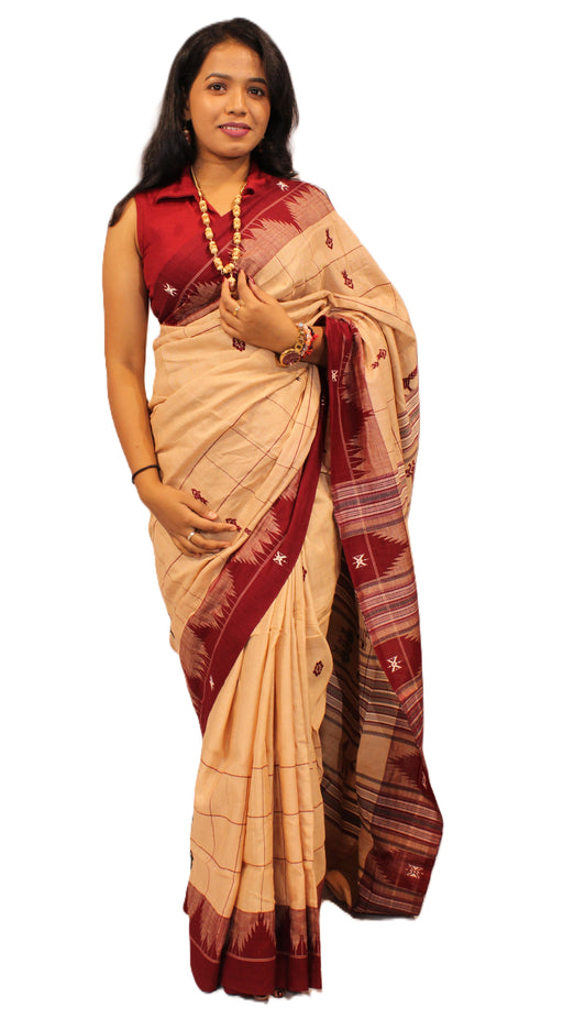 Elegant Kotpad saree handwoven in Odisha with natural Aul tree dyes and tribal motifs, includes blouse piece