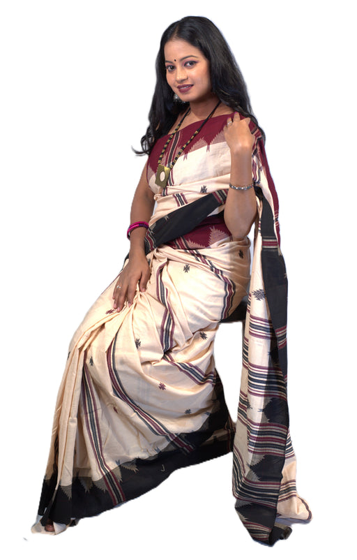 Elegant Kotpad saree handwoven in Odisha with natural Aul tree dyes, tribal motifs, and matching blouse piece