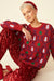 Red cashmere and banana blend women’s Christmas jumper with festive design.