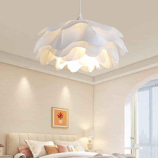 White Nordic pine cone pendant light with hand-knitted metal frame and adjustable suspension for home, café, and restaurant lighting.