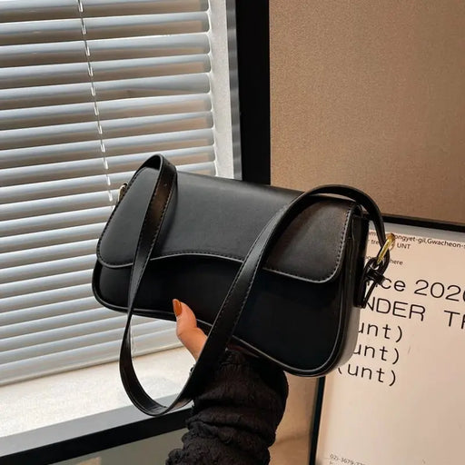 Women’s PU leather saddle crossbody bag with hasp closure and interior zipper pocket