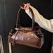 Women’s vintage PU casual tote bag with tassel detail, zipper closure, and spacious compartments