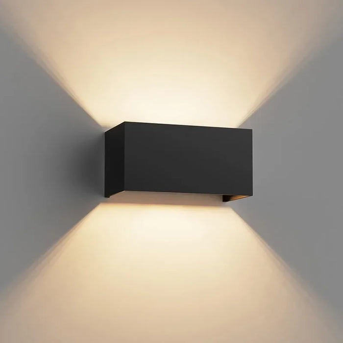 Modern aluminum LED wall lamp with adjustable beam installed on an outdoor wall