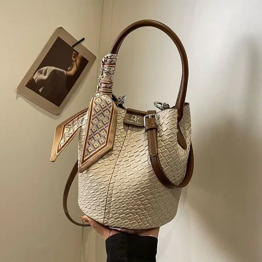 Women’s PU leather bucket handbag with zipper closure, knitting pattern, and dual straps for casual or business use.