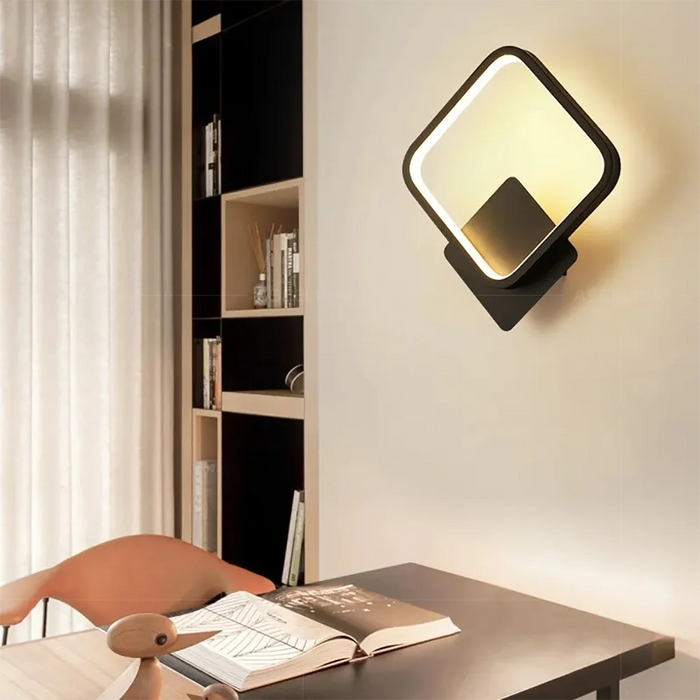 Modern LED wall light with die-cast aluminum finish, mounted in a bedroom with adjustable brightness and color settings