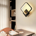 Modern LED wall light with die-cast aluminum finish, mounted in a bedroom with adjustable brightness and color settings