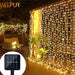 Solar-powered LED curtain lights in multicolor with IP65 waterproof design and remote control for outdoor holiday decoration