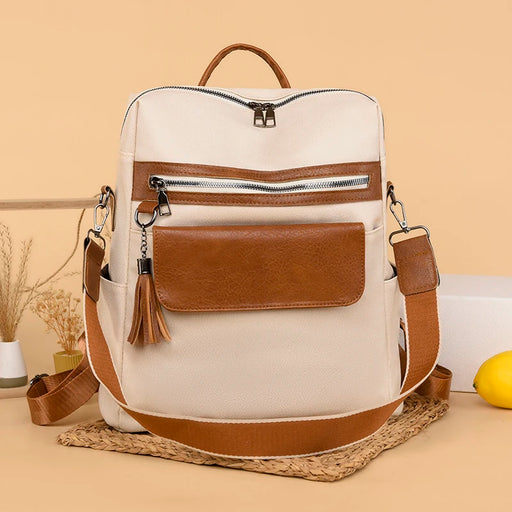 PU softback backpack for women with tassel decoration, embossed thread design, multiple interior compartments, and soft shoulder straps