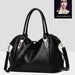 Large black pebbled leather women's tote handbag with dual top handles, gold-tone metal hardware, and removable adjustable shoulder strap