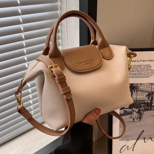 Trendy bucket messenger bag with barrel shape, flap closure, and crossbody strap for men and women