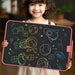 Rechargeable LCD writing tablet with color screen and stylus on a desk, showing a child drawing and adult note-taking use


