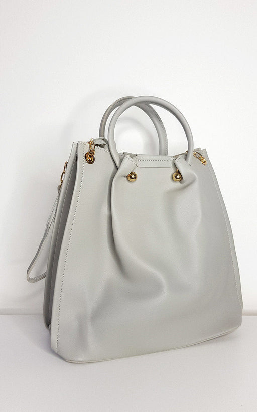 Beige faux leather handbag and shoulder bag set with gold hardware and detachable strap.