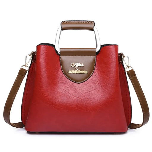 Luxury designer tote handbag in microfiber leather with a vintage design, zipper closure, and multiple compartments.
