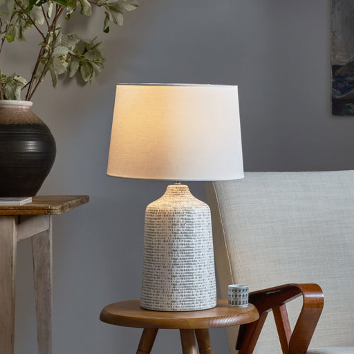 Modern ceramic table lamp with abstract grey and white glaze and ivory linen shade