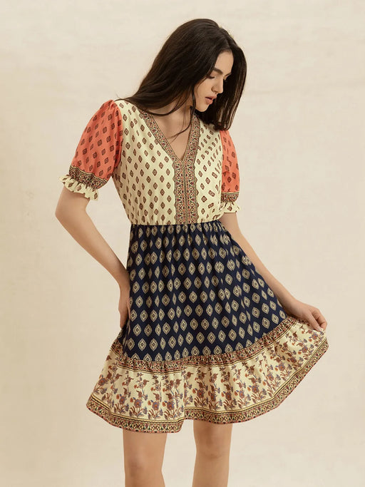 Woman wearing a V-neck short sleeve dress with ruched detail, styled for everyday wear
