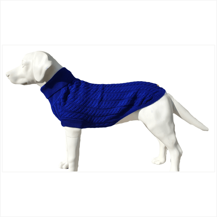 
A dog wearing a peacock blue cable knit jumper with a roll neck and leg sleeves