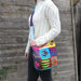 Handcrafted bohemian sling bag with Om symbol embroidery, adjustable strap, and eco-friendly materials.
