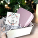 Small Christmas gift set featuring a silver star necklace on a message card and a square pink PU leather travel jewellery box with a silver zip.