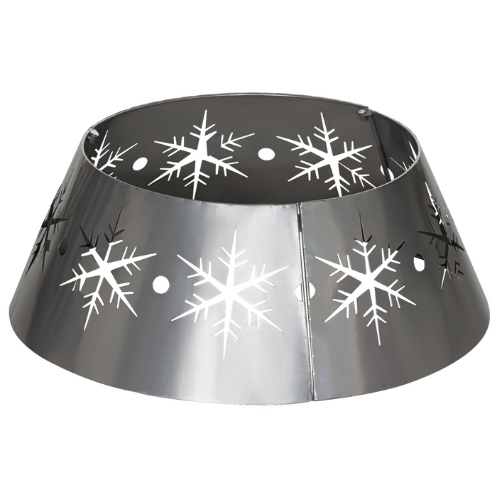 Silver metal Christmas tree collar featuring a detailed snowflake pattern, shown covering a tree base for a neat and festive holiday display.